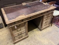 An early 20th century limed oak pedestal desk bears plaque 'Vaughan Williams O.M. composed at this