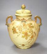 A Royal Worcester two handled ovoid vase moulded and gilded with flowers on a blush ivory ground,