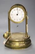 A Tiffany brass 'never wind' electric clock, under glass dome, missing many parts