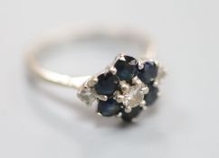 A white metal (stamped 18ct), sapphire and diamond cluster ring, size M, gross 4.2 grams.