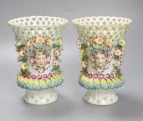 A pair of Continental frill vases with pierced necks and applied mask heads encrusted with