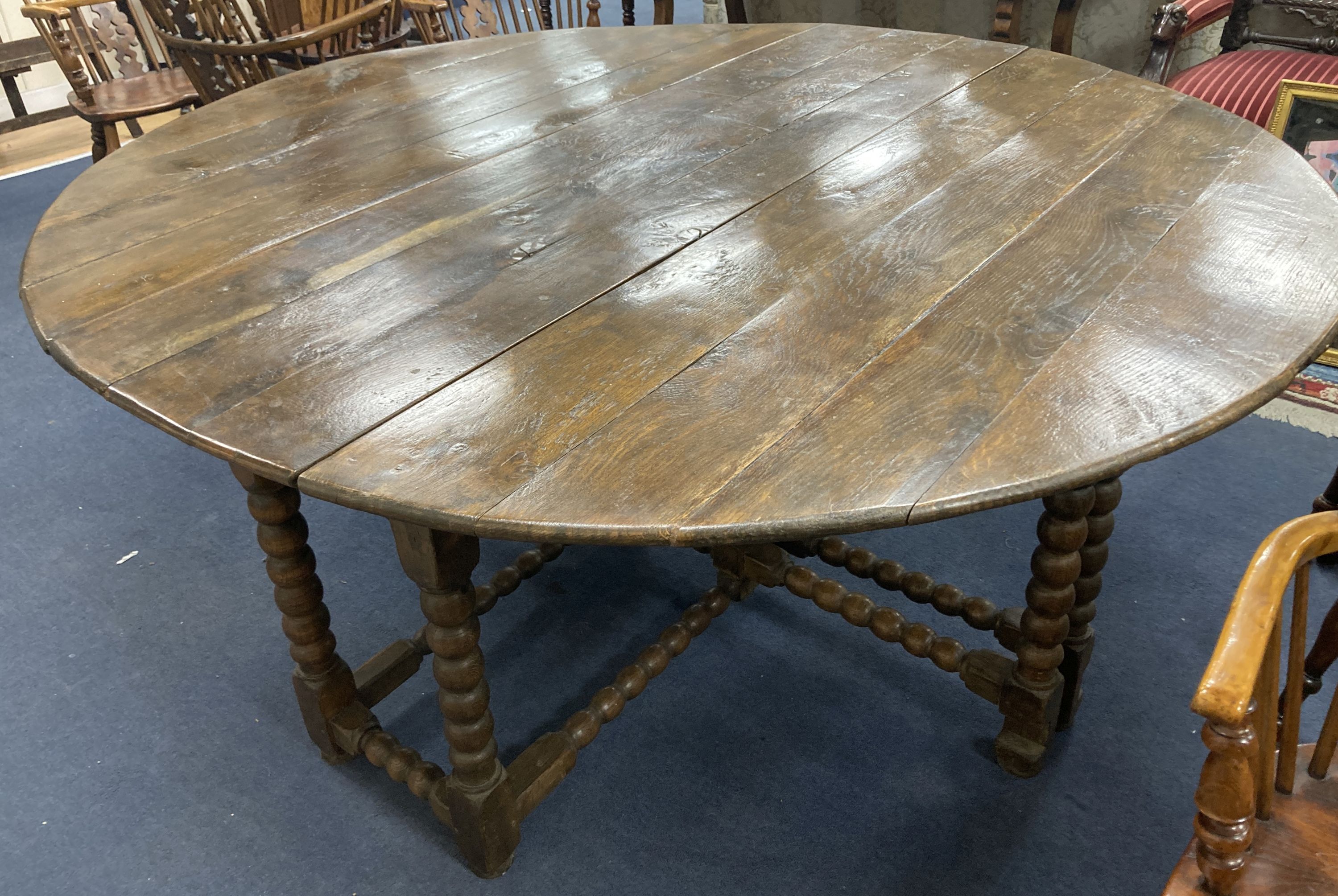 An 18th century and later oak bobbin leg gateleg dining table, length 170cm extended, width 162cm,