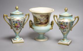 A Derby urn, 'In Italy', height 17cm and a pair of French porcelain urns and covers