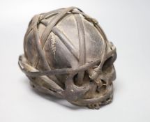 A bound Asmat human skull, possibly head hunters