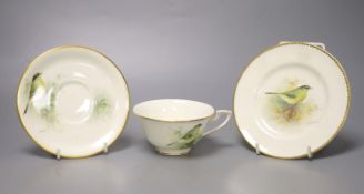 A Royal Worcester teacup, saucer and side plate, each unusually painted with a thrush on a branch by