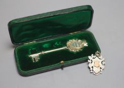A cased Edwardian parcel gilt silver presentation key, Birmingham, 1908, 10.2cm and a late Victorian