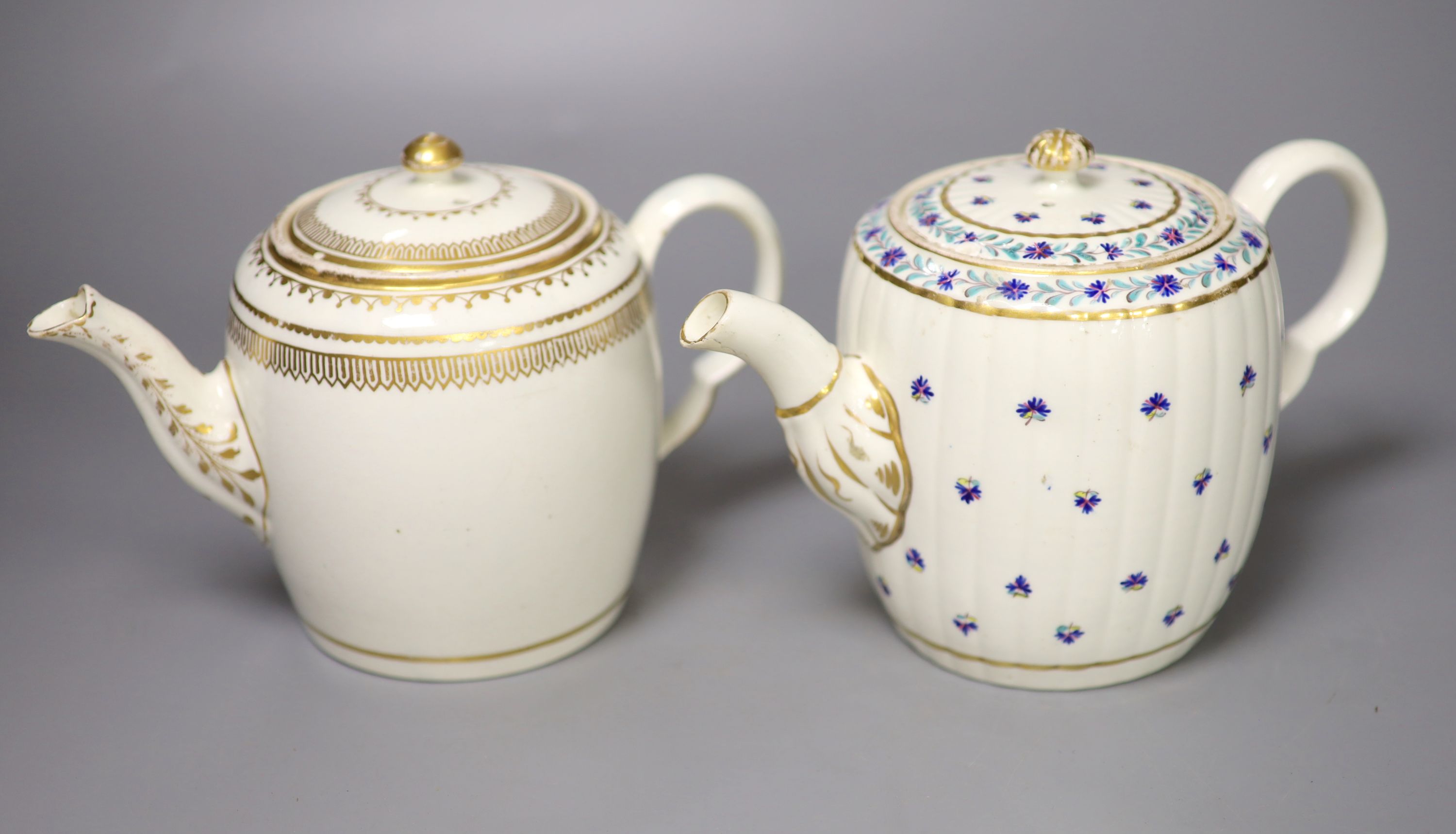 A Caughley teapot and cover, painted with cornflowers and another Caughley teapot and cover with