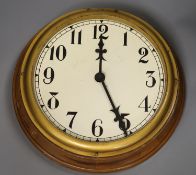 An oak cased electric slave dial, diameter 31cm