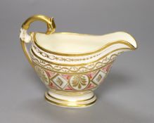 A rare English porcelain sauceboat, with swan neck handle gilded with alternating oval and diamond