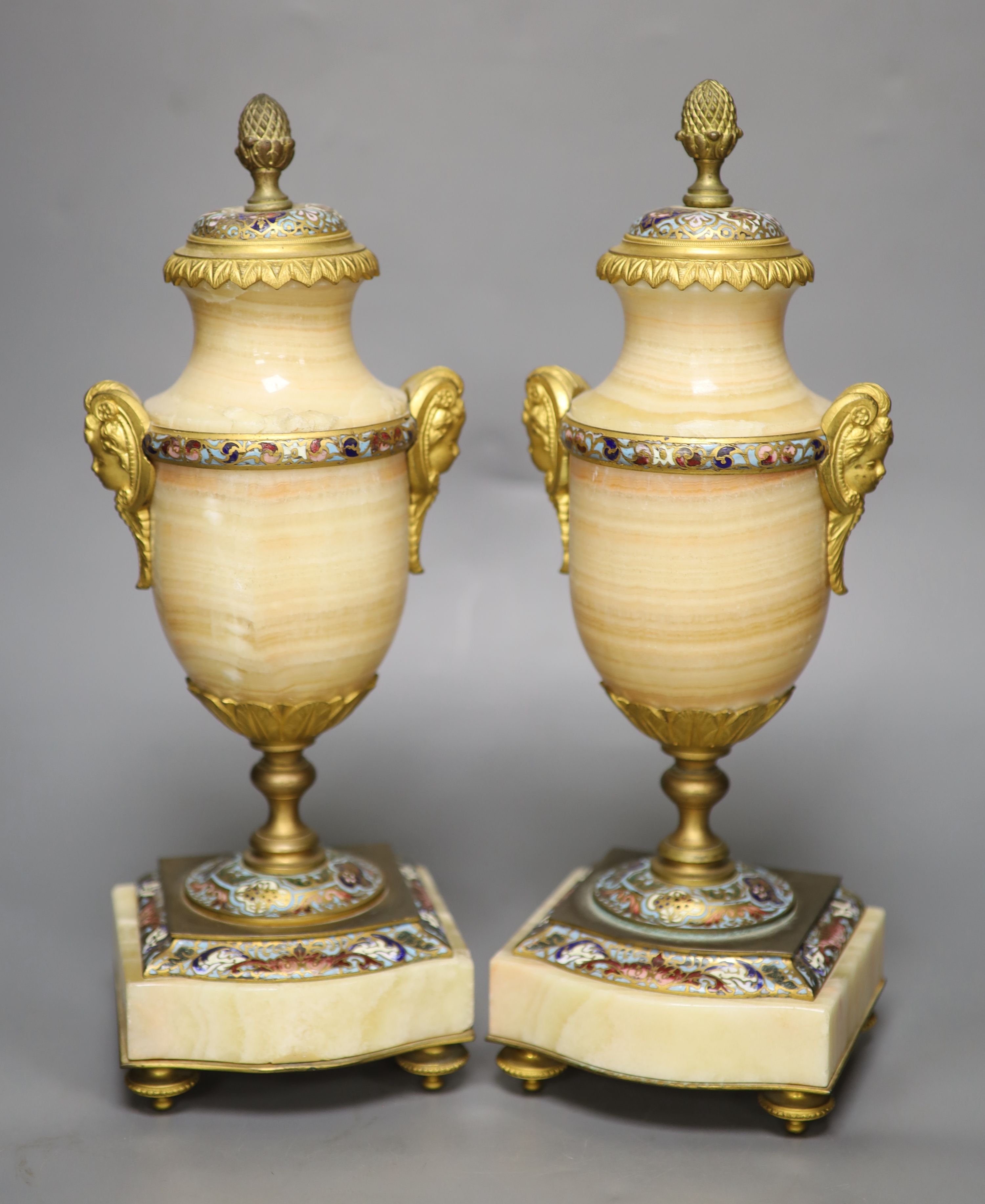 A pair of late 19th century alabaster and champleve enamel urns (formerly part of a clock