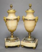 A pair of late 19th century alabaster and champleve enamel urns (formerly part of a clock
