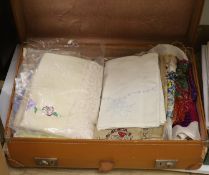 A suitcase of mixed textiles, woolworks etc