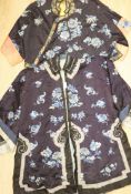 Two Chinese early 20th century embroidered silk jackets, each worked with blue and white peonies and