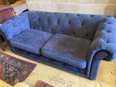 A pair of Chesterfield style settees upholstered in blue dralon and a footstool, largest length