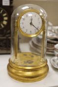 A Tiffany brass 'never wind' electric clock, under glass dome, overall height 32cm