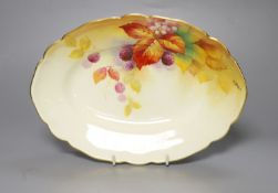 A Royal Worcester oval dish painted with autumnal leaves and berries by Kitty Blake, signed, date