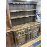 An early 20th century Jacobean style oak dresser, width 150cm, depth 47cm, height 199cm