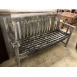 A weathered teak garden bench, length 150cm, depth 55cm, height 86cm