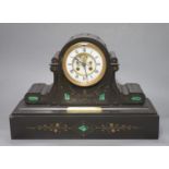 A Victorian black marble and inlaid malachite eight day mantel clock, plaque reads 'Presented to