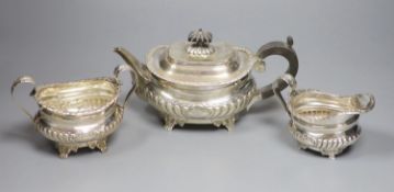 A late Victorian demi fluted silver three piece tea set, Charles Stuart Harris, London, 1899,