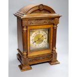 A German walnut mantel clock, converted to electric regulation, height 44cm