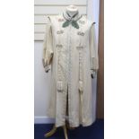 An Edwardian ladies fine cream wool coat with embroidered cuffs front edging and collar and ornate