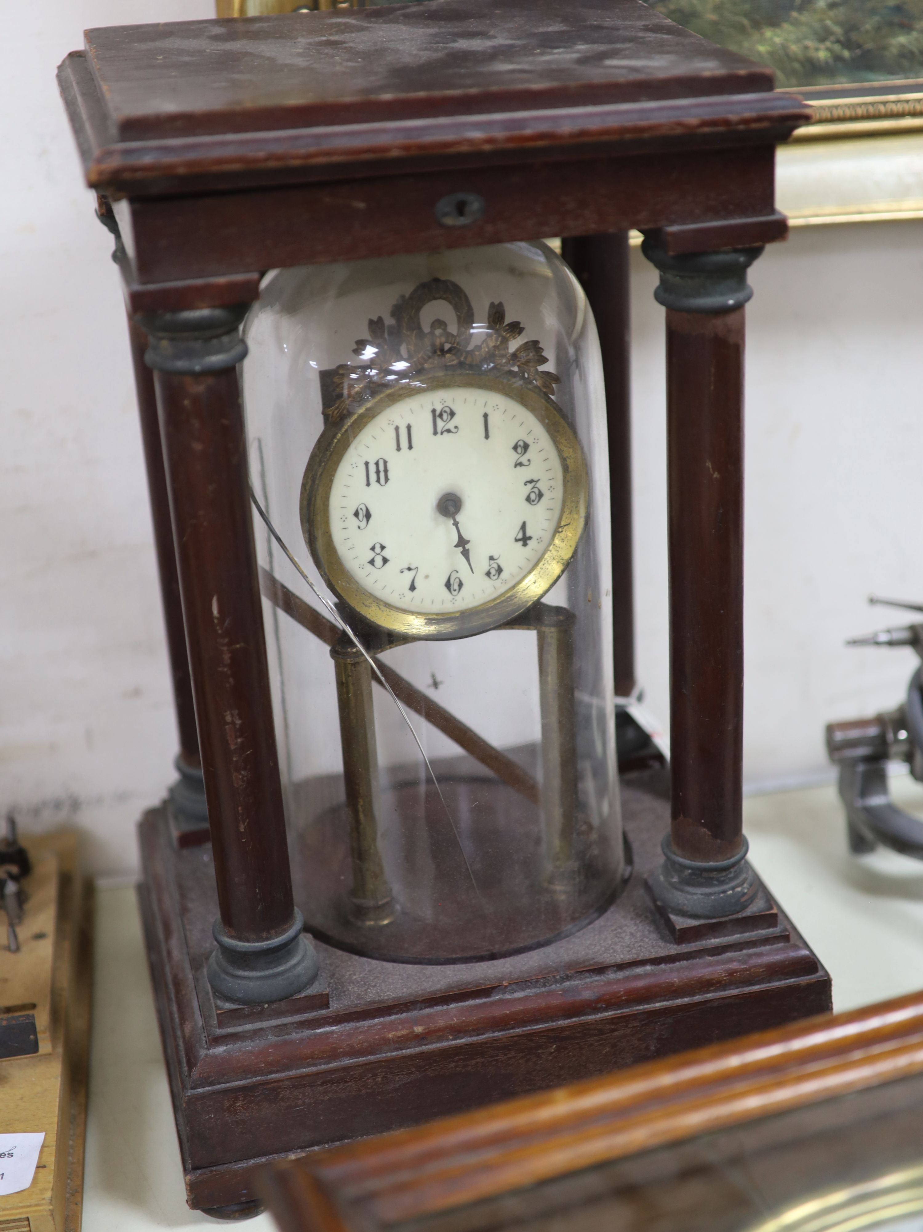 An early 20th century mahogany and brass electric mantel clock, with integral glass dome,