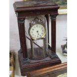 An early 20th century mahogany and brass electric mantel clock, with integral glass dome,