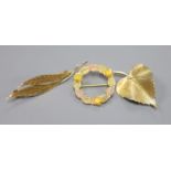 A 585 yellow metal double leaf brooch, 51mm, 2.5 grams, a 9ct gold leaf brooch, 3 grams and a 10k