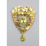 A pierced yellow metal and four stone peridot set brooch(adapted), 52mm, gross 9.7 grams.