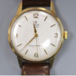 A gentleman's early 1960's 9ct gold Tudor Royal manual wind wrist watch, on associated leather