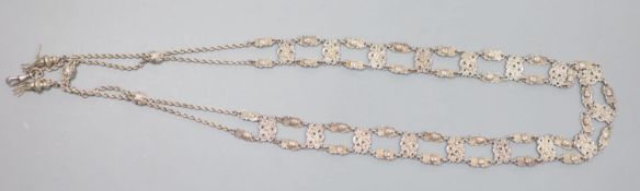 An Edwardian long silver openwork panel link and ropetwist chain tassel necklace, with mask