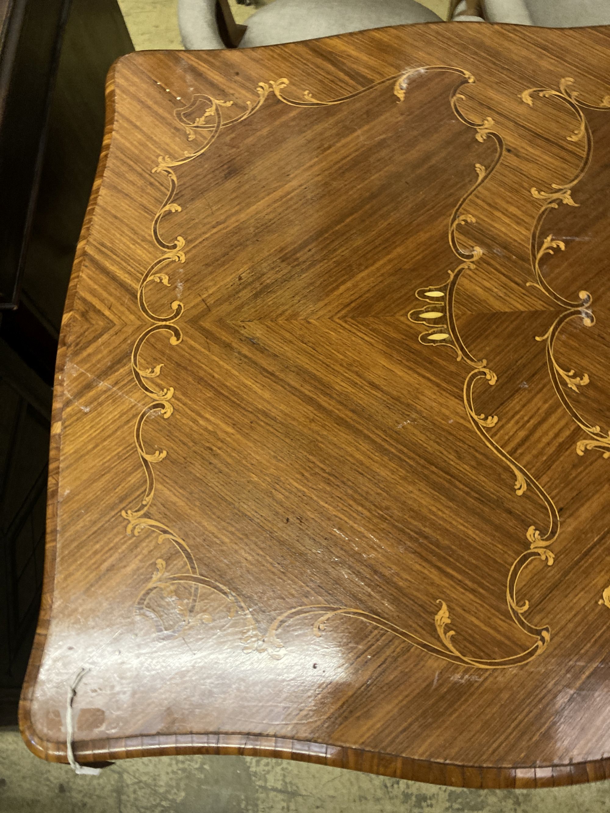 A Louis XVI design marquetry inlaid kingwood serpentine centre table W.196cm. D 90cm. H 79cm. - Image 4 of 6