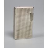 An early 1960's silver Dunhill lighter, 54mm.CONDITION: Small dent to the side of the case below the