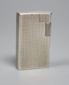 An early 1960's silver Dunhill lighter, 54mm.CONDITION: Small dent to the side of the case below the