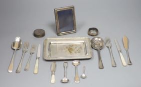 An 800 white metal stand, 16.4cm, twelve items of assorted silver flatware, a silver napkin ring,