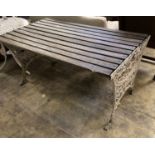 A Victorian style slatted rectangular cast metal base garden table, length 124cm, depth 68cm, height