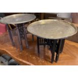 Two Benares engraved circular tray top tables, larger 59cm diameter, 53cm high