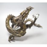 A large Japanese bronze model of a dragon clasping a glass 'jewel', 29.5cm across