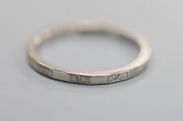 A shape white metal ( stamped platinum) wedding band, size M, 3.3 grams.