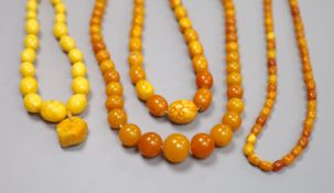 Four assorted single strand amber bead necklaces, largest 62cm, gross weight 86 grams.