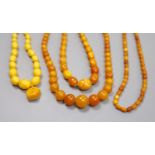 Four assorted single strand amber bead necklaces, largest 62cm, gross weight 86 grams.