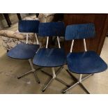 A set of three mid century stained beech and metal childs' swivel chairs