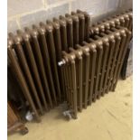 Four cast iron radiators, one vintage, three modern, largest width 64cm, height 91cm