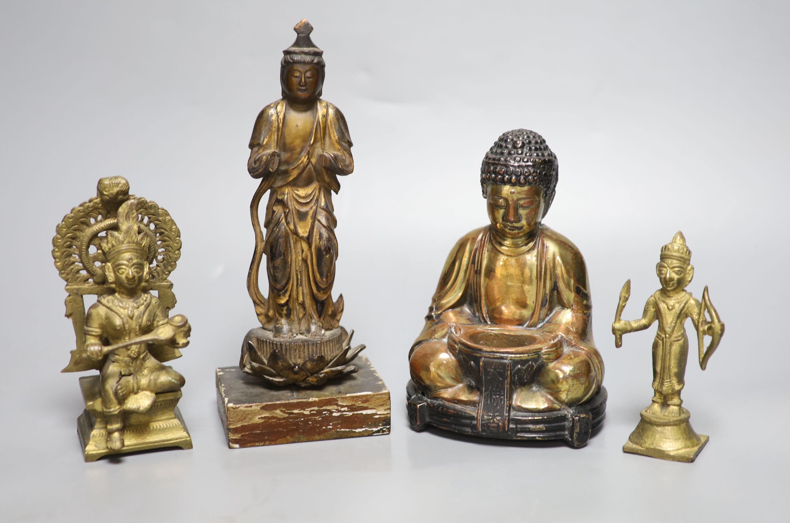 A Japanese gilt lacquered standing Buddha, a gilt copper Buddha and two Indian figures, tallest