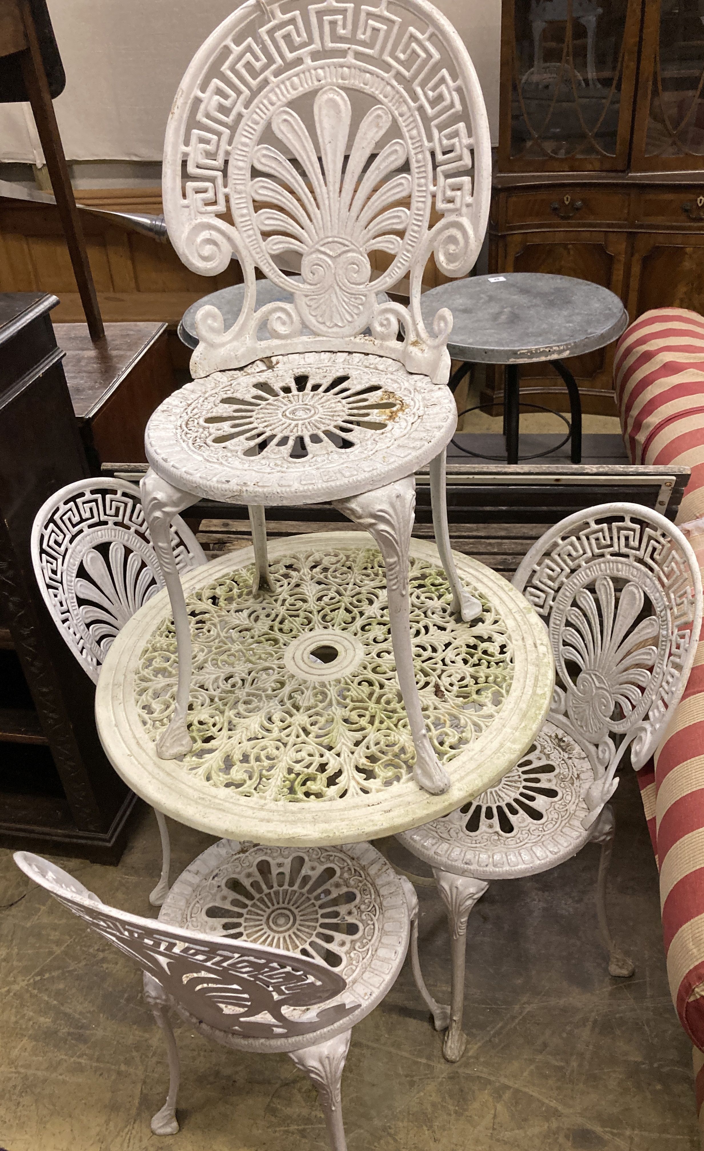 A circular Victorian style painted aluminium garden table, diameter 69cm together with a set of four
