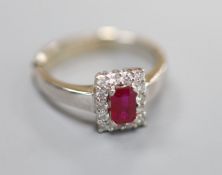 A modern 18ct white gold, ruby and diamond set rectangular cluster ring, size P/Q, gross 6 grams.