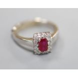 A modern 18ct white gold, ruby and diamond set rectangular cluster ring, size P/Q, gross 6 grams.