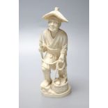 A Japanese Meiji period carved ivory figure of a fisherman, height 20cm