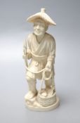 A Japanese Meiji period carved ivory figure of a fisherman, height 20cm